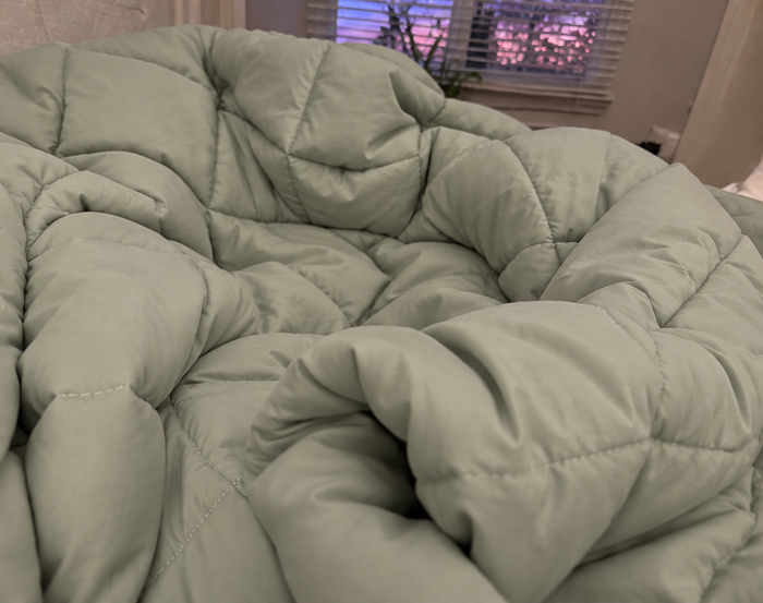 AI-generated demo image of the HelloBed Sage comforter in a home setting.