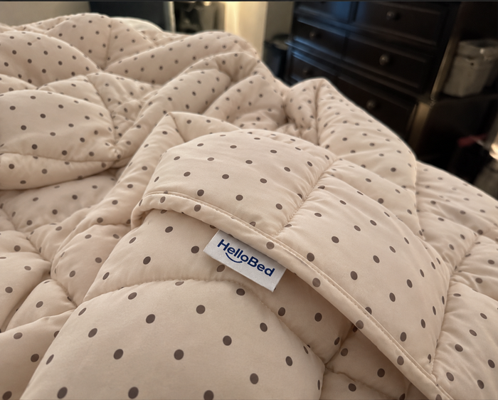 AI-generated demo image of the HelloBed Sand Dot comforter in a home setting.
